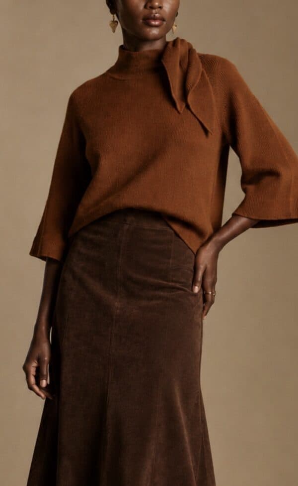 Elegant rust-coloured cape knit top with high neck and wide sleeves from Aimee Joyce London.