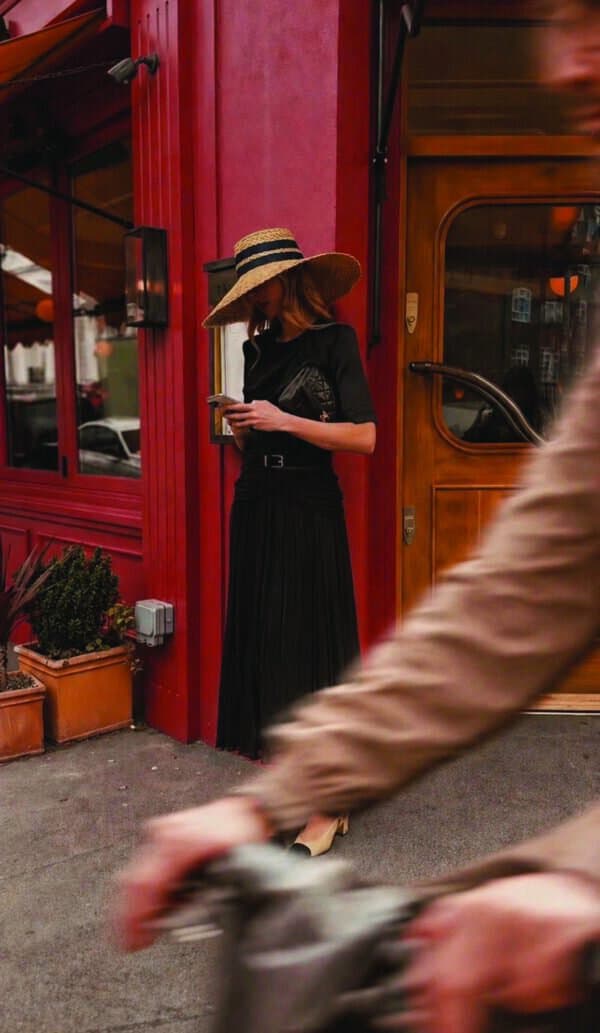 A lady stood in front of a luxury womenswear boutique in a women's coord in London.