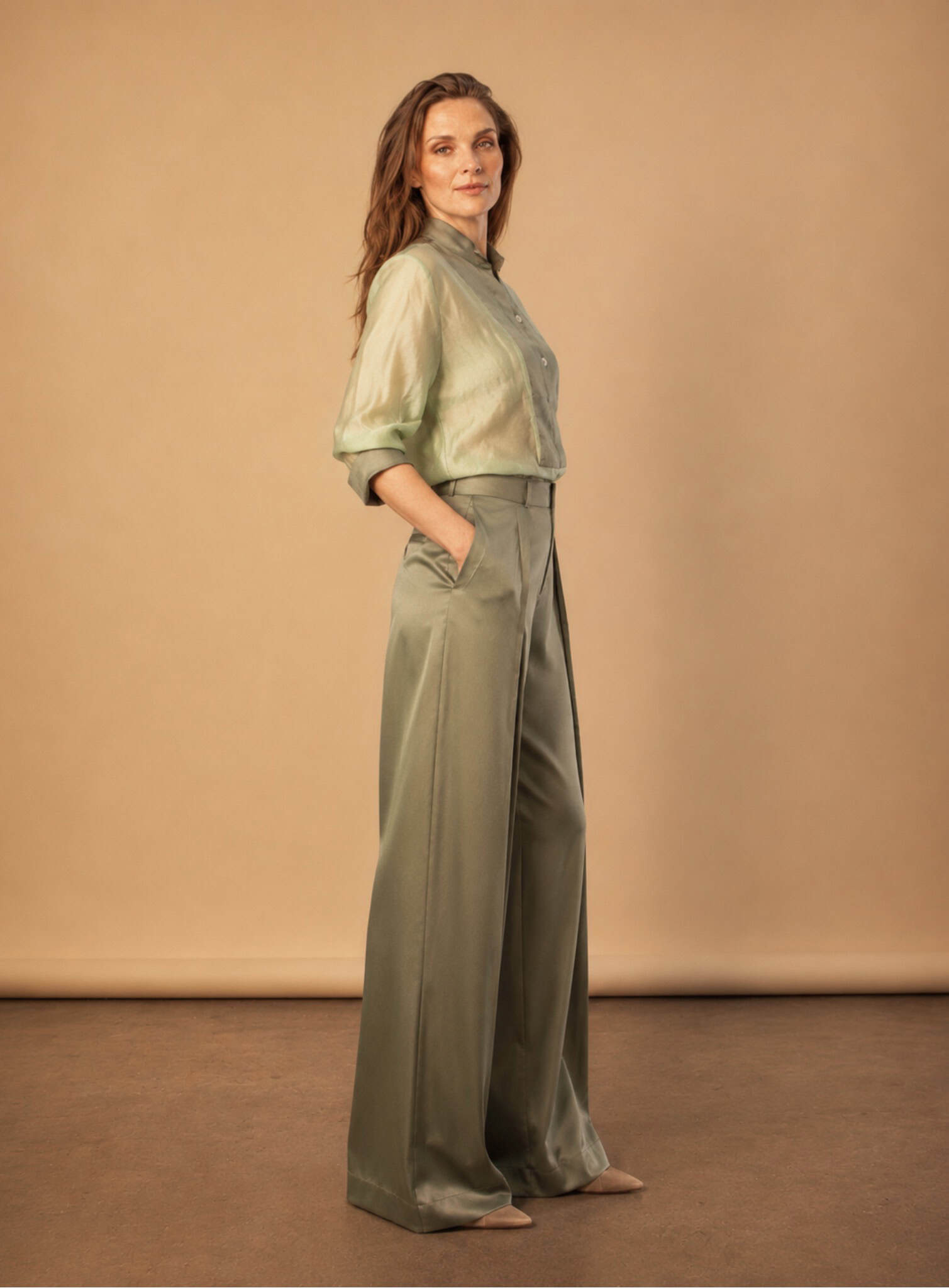 The Sage Tux Shirt 4 sage tux shirt Elegant woman in sage green tux shirt and wide-leg trousers.