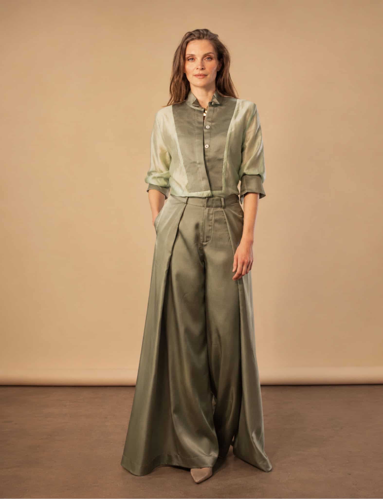 The Sage Tux Shirt 8 sage tux shirt Elegant woman in sage green tux shirt and wide-leg trousers for a sophisticated style.