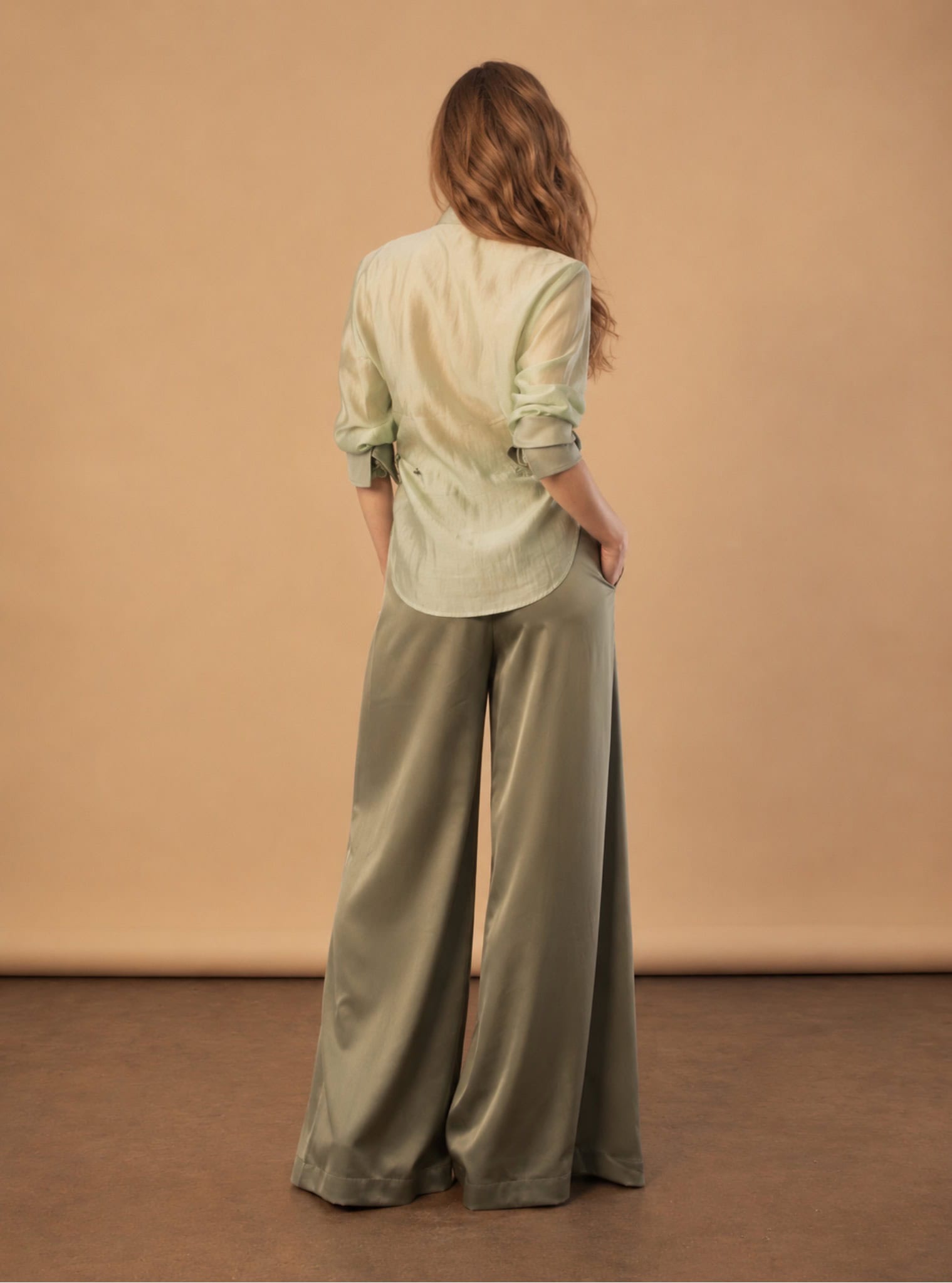 The Sage Tux Shirt 6 sage tux shirt Elegant woman in sage tux shirt and wide-leg trousers from Aimee Joyce London.
