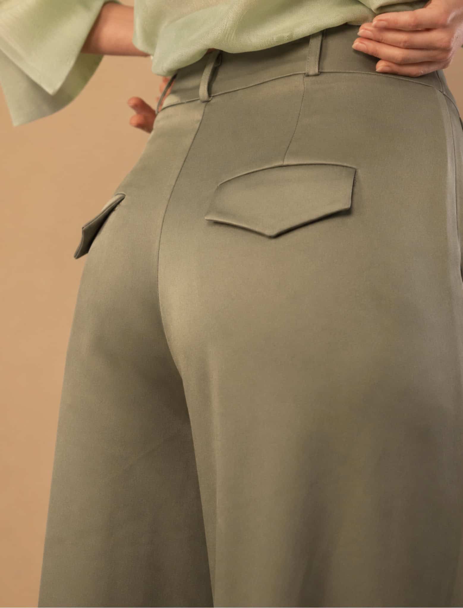 Sage Pleated Palazzo Pant 7 Close-up of stylish green trousers with back pockets from Aimee Joyce London.