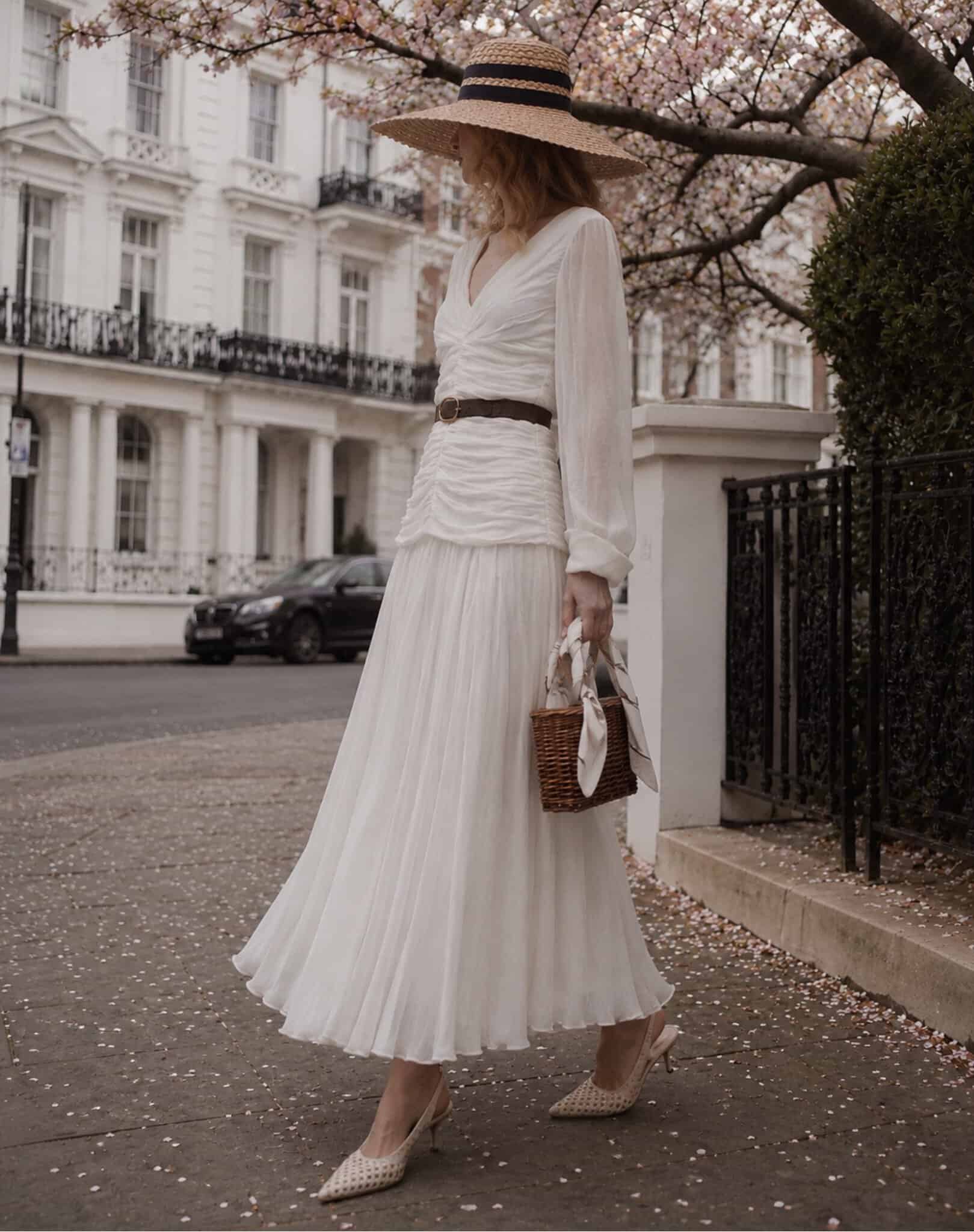 The Audrey 7 champagne tux shirt Elegant woman in white dress with straw hat and basket bag in London.