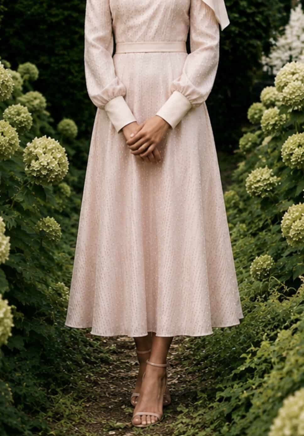The Long-sleeved Catherine dress 6 Elegant long-sleeved dress by Aimee Joyce London in a garden setting.