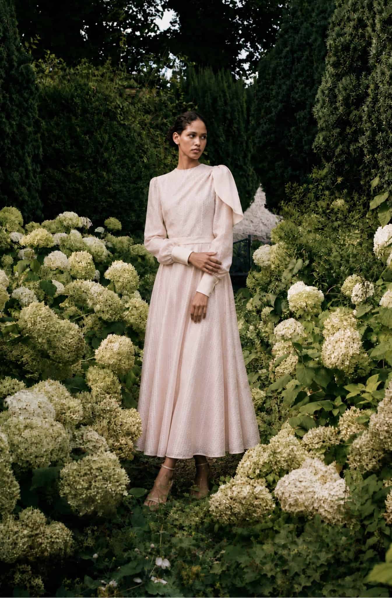 The Long-sleeved Catherine dress 4 Elegant long-sleeved dress by Aimee Joyce London in a garden setting.