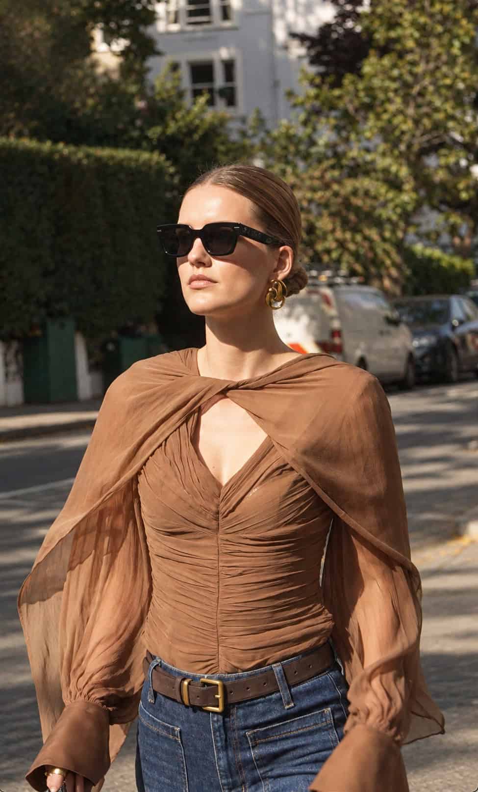 Tobacco Audrey blouse with a ruched front and chiffon cape, styled with blue jeans.