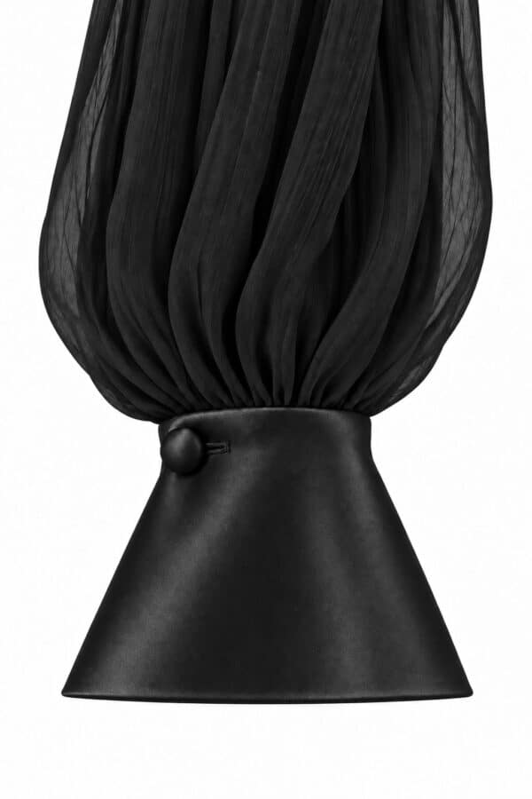 Close-up of the black Audrey blouse's gathered chiffon sleeve and satin cuff with a covered button.