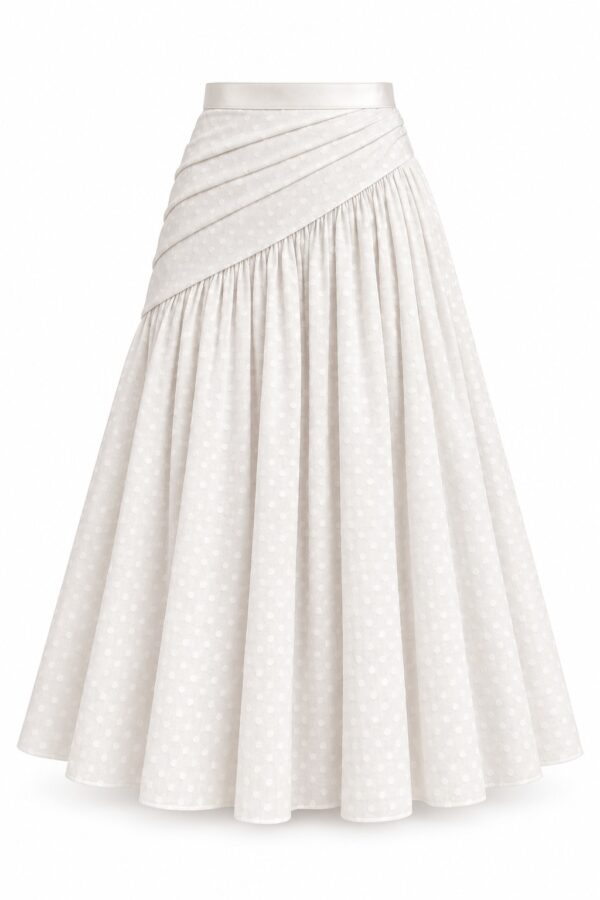 The white Gilda Skirt shown on an invisible mannequin against a white background, with draped polka-dot cotton yoke, satin waistband and full gathered midi skirt.